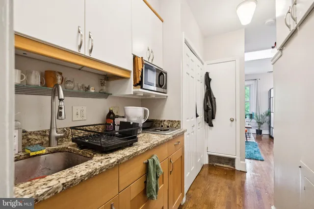 a kitchen with stainless steel appliances granite countertop a sink a stove and a refrigerator