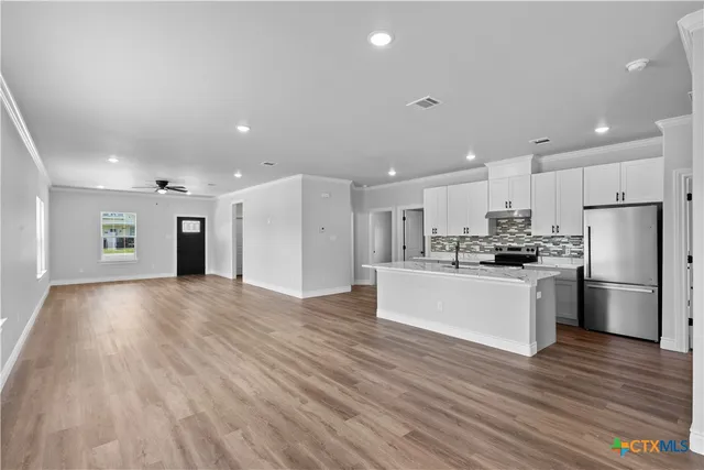 a kitchen with a refrigerator and a sink