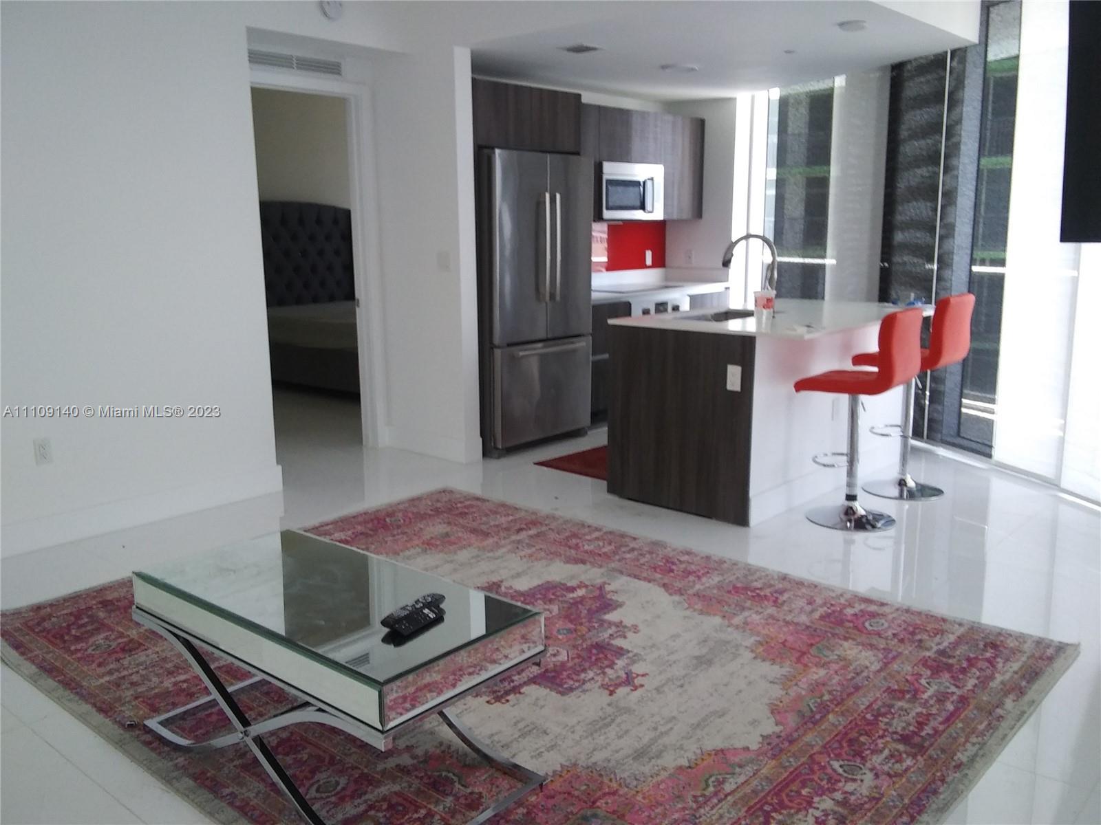 Edgewater Miami, FL 33132 - Photo 2 of 19 a living room with stainless steel appliances kitchen island granite countertop furniture and a rug