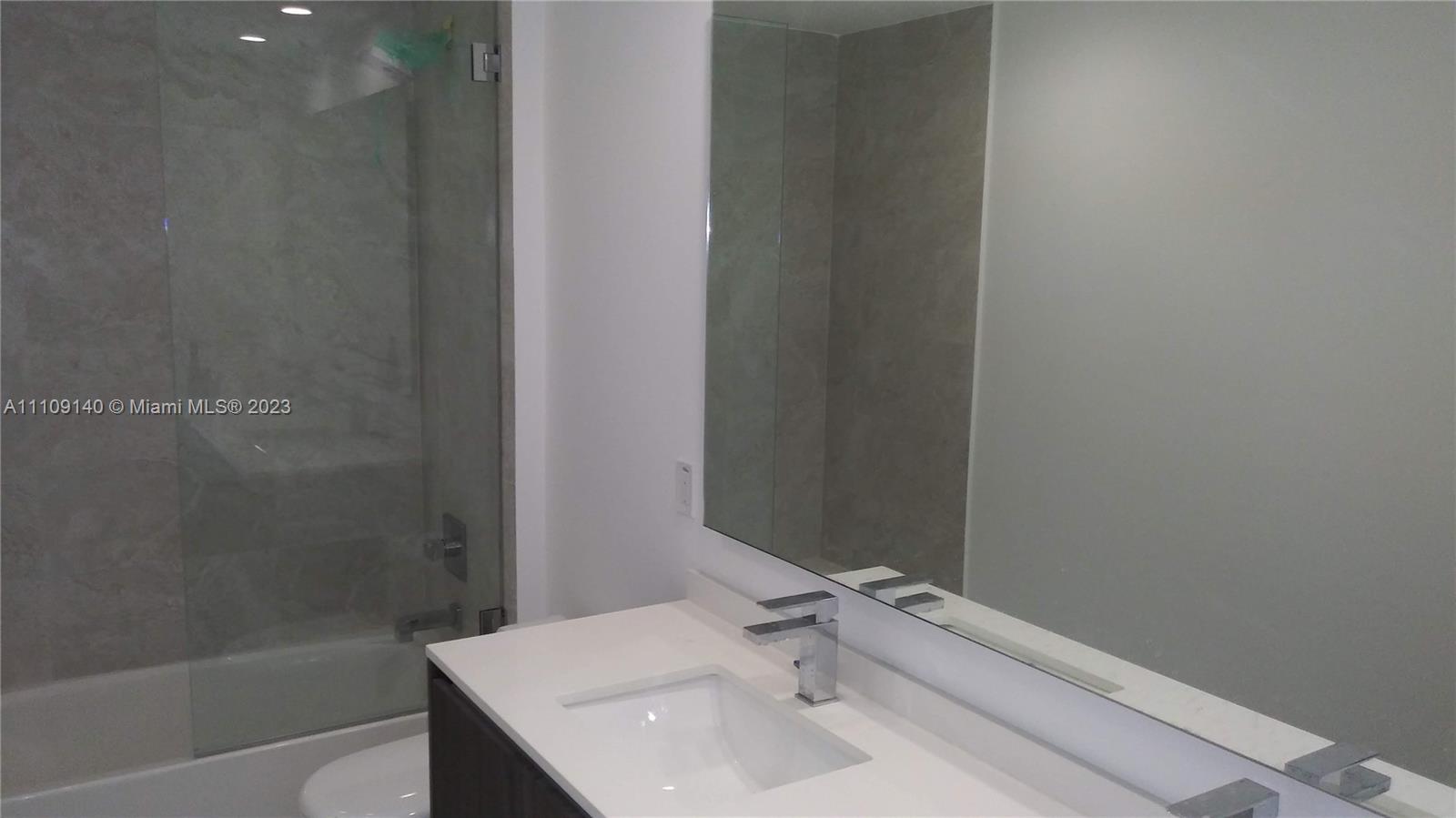 Edgewater Miami, FL 33132 - Photo 6 of 19 a bathroom with a sink and a mirror