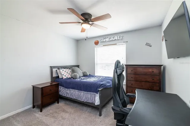 a bedroom with a bed closet and flat screen tv