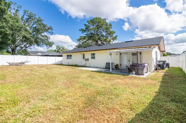 a view of a house with swimming pool and a yard