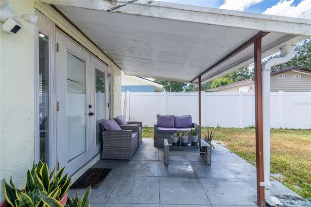 a view of a patio with table and chairs potted plants with wooden floor