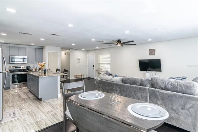 a living room with furniture and a wooden floor