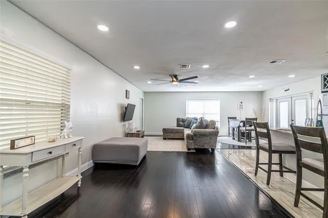 a living room with furniture and wooden floor