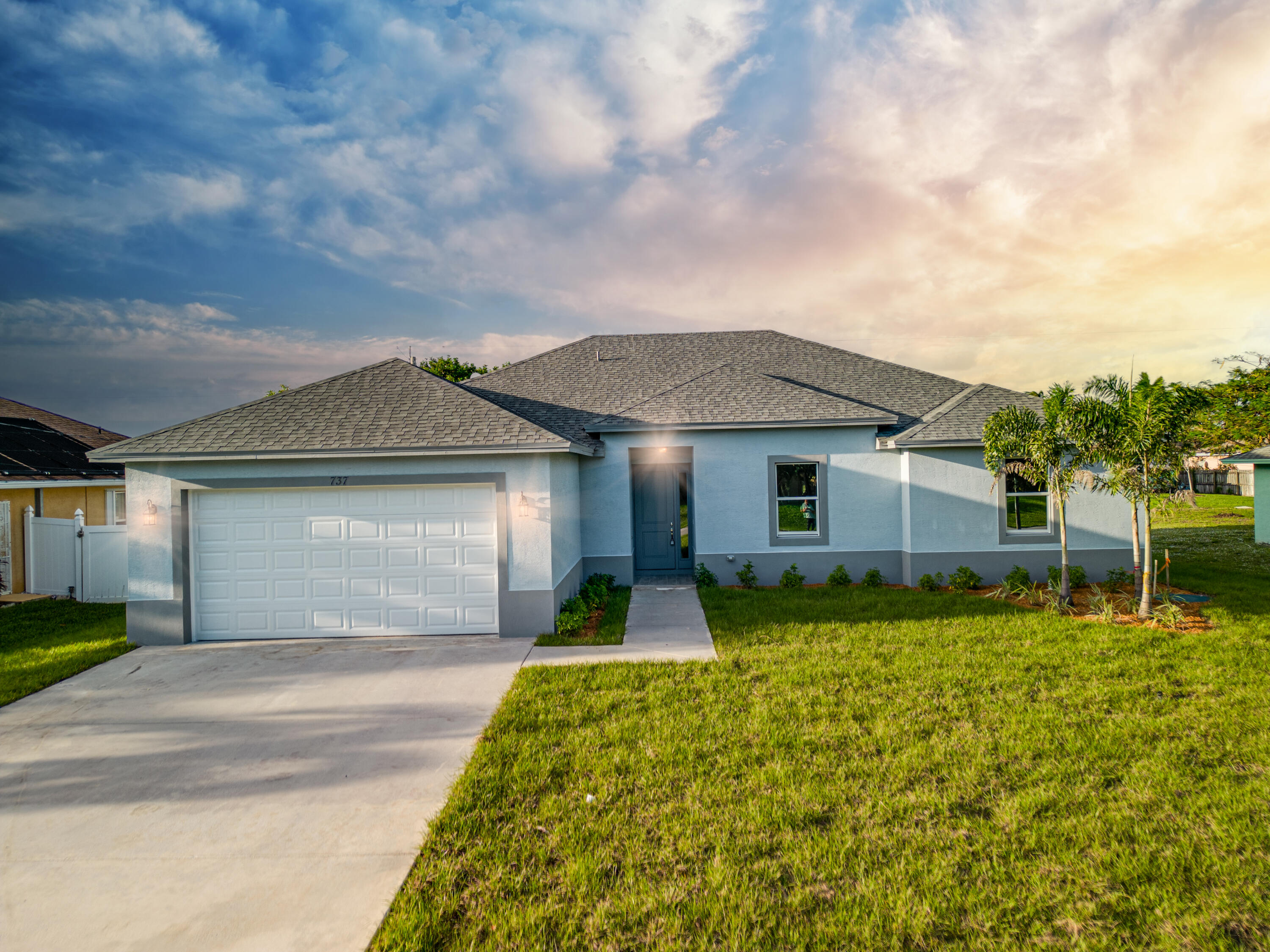 5517 Northwest Downs Street Port St. Lucie, FL 34986 - Photo 1 of 29 a front view of a house with garden