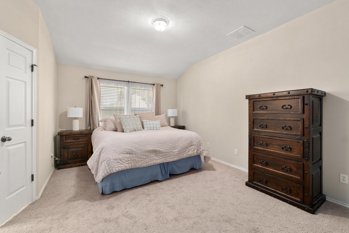11201 Old Quarry Road Austin, TX 78717 - Photo 16 of 33 a bedroom with a bed and a dresser