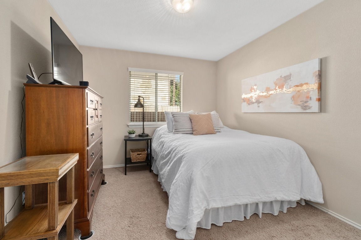 11201 Old Quarry Road Austin, TX 78717 - Photo 21 of 33 a bedroom with a bed and a flat screen tv