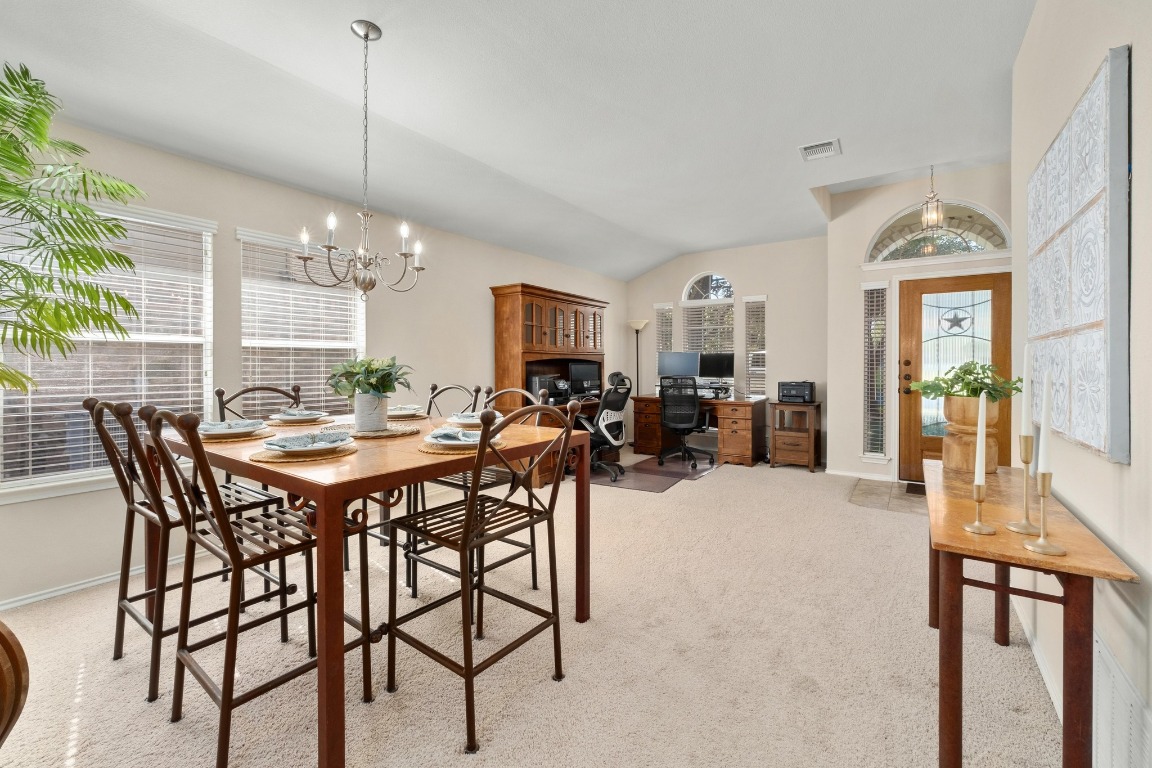 11201 Old Quarry Road Austin, TX 78717 - Photo 5 of 33 a view of a dining room and livingroom with furniture wooden floor a chandelier