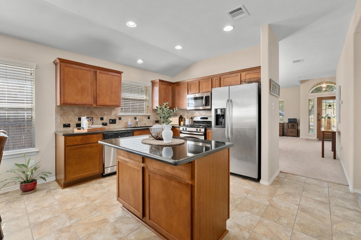 11201 Old Quarry Road Austin, TX 78717 - Photo 10 of 33 a kitchen with stainless steel appliances granite countertop a stove a sink a refrigerator and a refrigerator