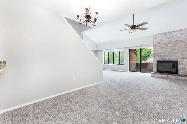 a view of an empty room with a fireplace