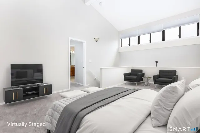 a bedroom with a bed a television and dresser