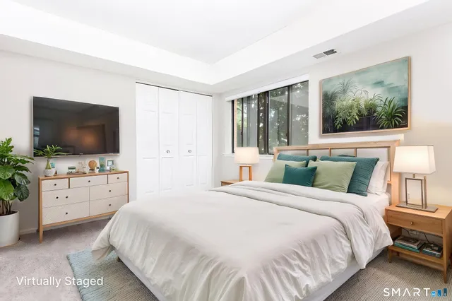 a bedroom with a bed and a flat screen tv