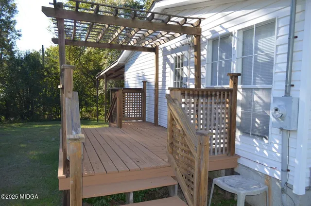 a view of a backyard with a trees and wooden fence