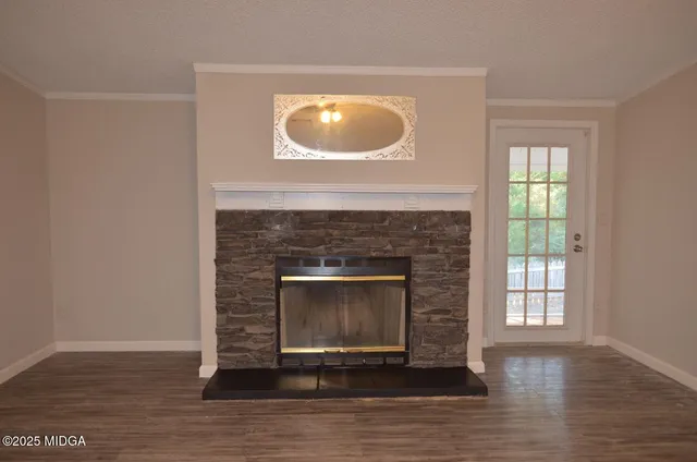 a living room with a fireplace and a wooden floor