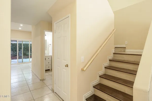 a view of entryway with wooden floor and stairs