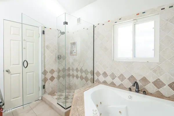 a bathroom with a bathtub and shower