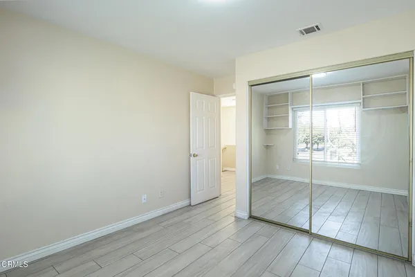 an empty room with wooden floor and door