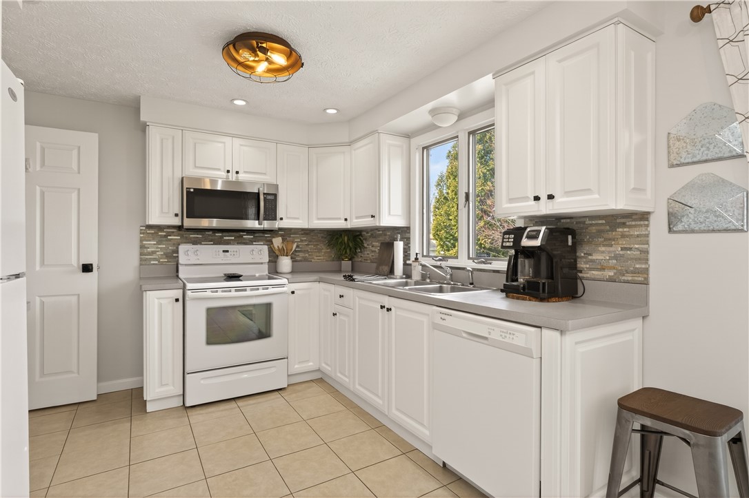 91 Emerald Point Chili, NY 14624 - Photo 12 of 36 Updated kitchen featuring white shaker-style cabin