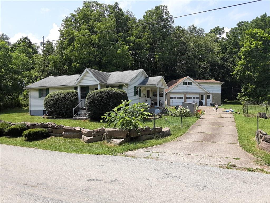 211 Rural Valley Road Claysville, PA 15323 - Photo 2 of 22 a front view of a house with a garden