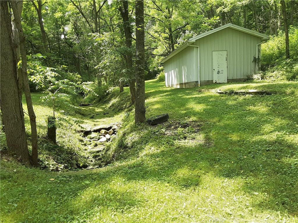 211 Rural Valley Road Claysville, PA 15323 - Photo 3 of 22 a backyard of a house with plants and large tree