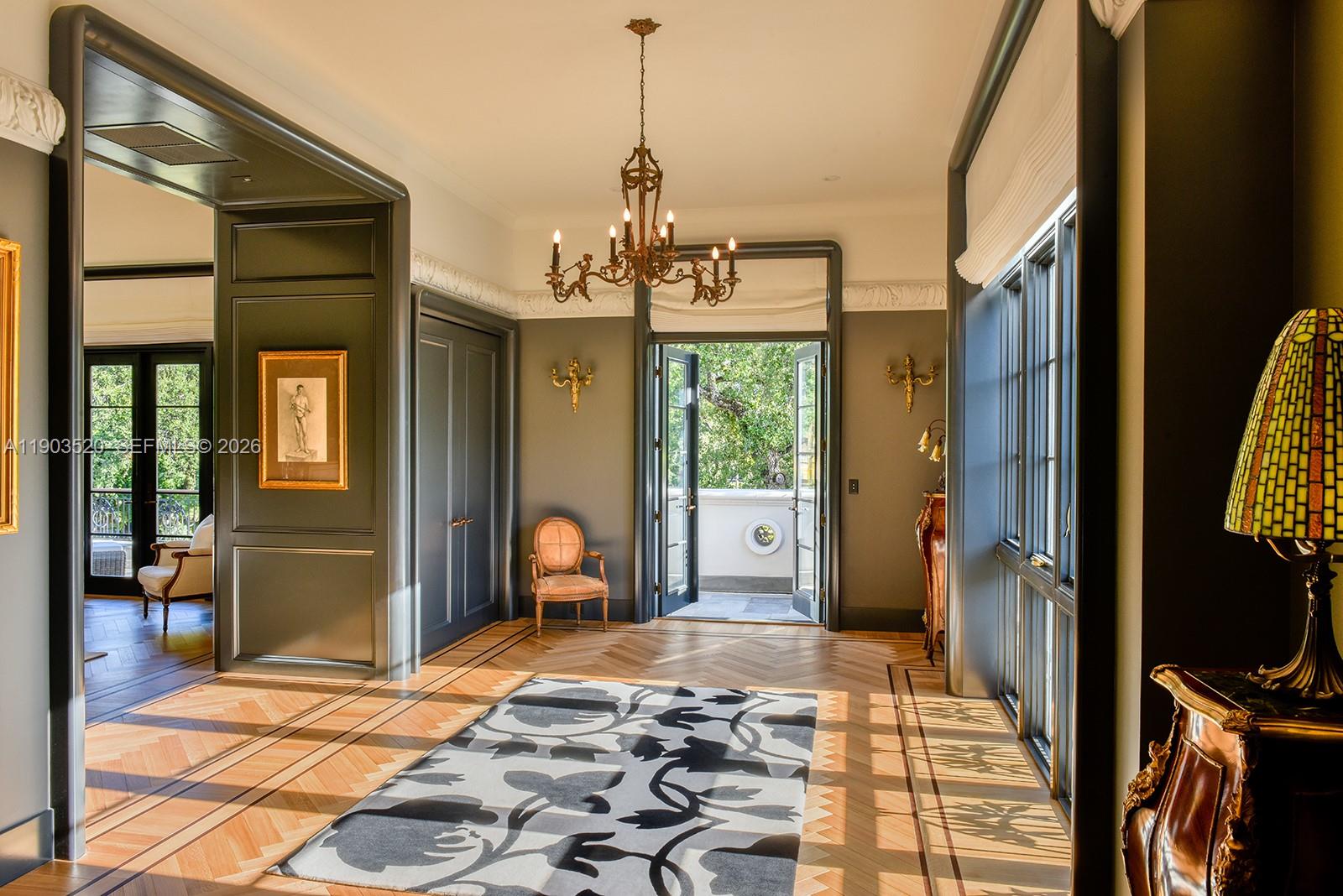 5771 Southwest 94th Street Pinecrest, FL 33156 - Photo 12 of 47 a bedroom with a bed and a chandelier