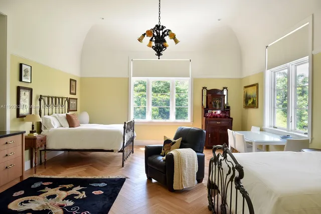 a living room with furniture fireplace and a large window