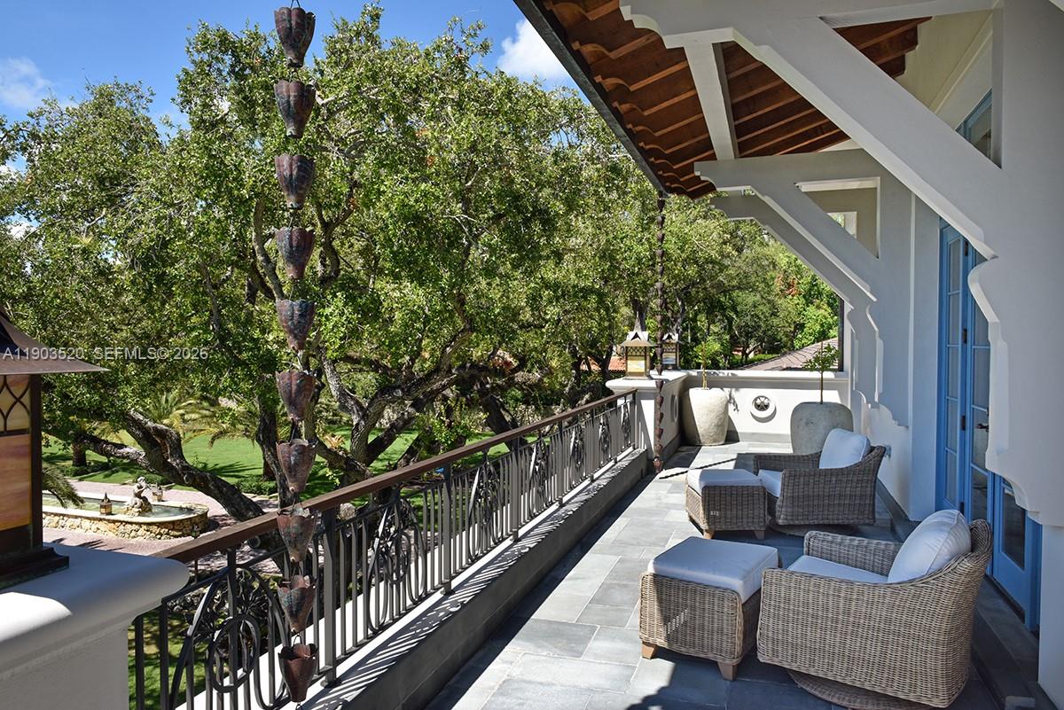 5771 Southwest 94th Street Pinecrest, FL 33156 - Photo 19 of 47 a balcony with wooden floor and outdoor seating
