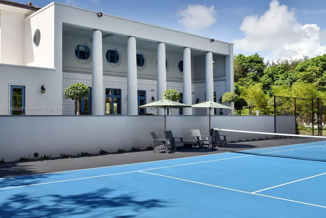 a view of a chairs and table in the patio and a fountain