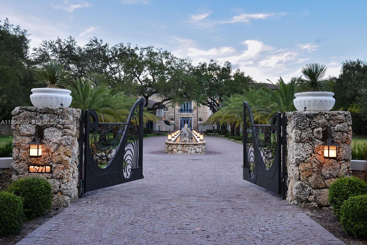 5771 Southwest 94th Street Pinecrest, FL 33156 - Photo 2 of 47 a view of a chairs and table in the patio and a fountain