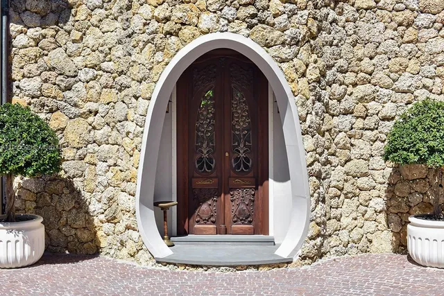 a kitchen with stainless steel appliances a table and chairs