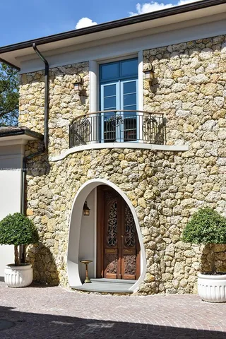 a front view of a house with porch and garden