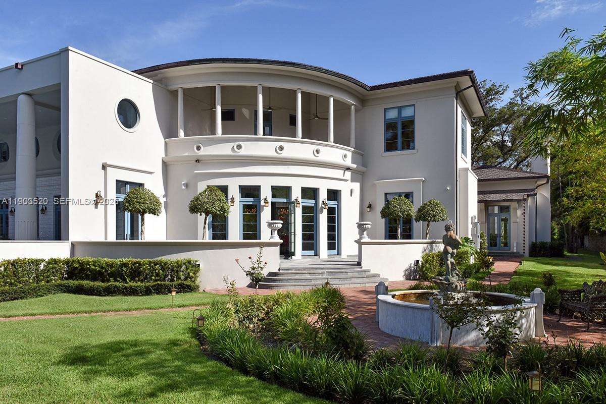 5771 Southwest 94th Street Pinecrest, FL 33156 - Photo 44 of 47 a front view of a house with porch and garden