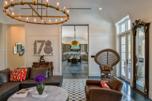 a living room with furniture and a chandelier