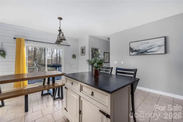 a view of a room with a table and chairs