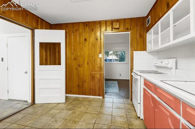 a kitchen with a sink and a refrigerator