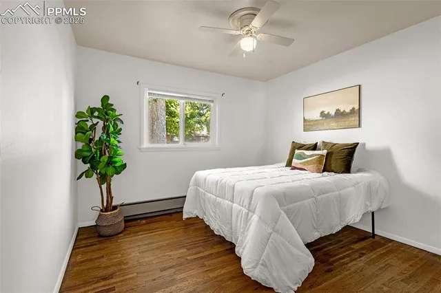 a bedroom with a bed and a potted plant