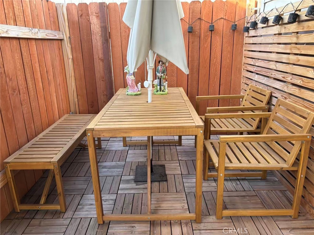 3825 Valley Boulevard, Unit 58 Walnut, CA 91789 - Photo 11 of 11 a view of a balcony with wooden floor and outdoor seating
