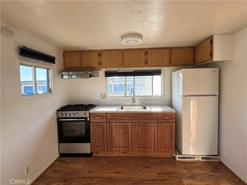 3825 Valley Boulevard, Unit 58 Walnut, CA 91789 - Photo 5 of 11 a kitchen with a stove a refrigerator and a refrigerator