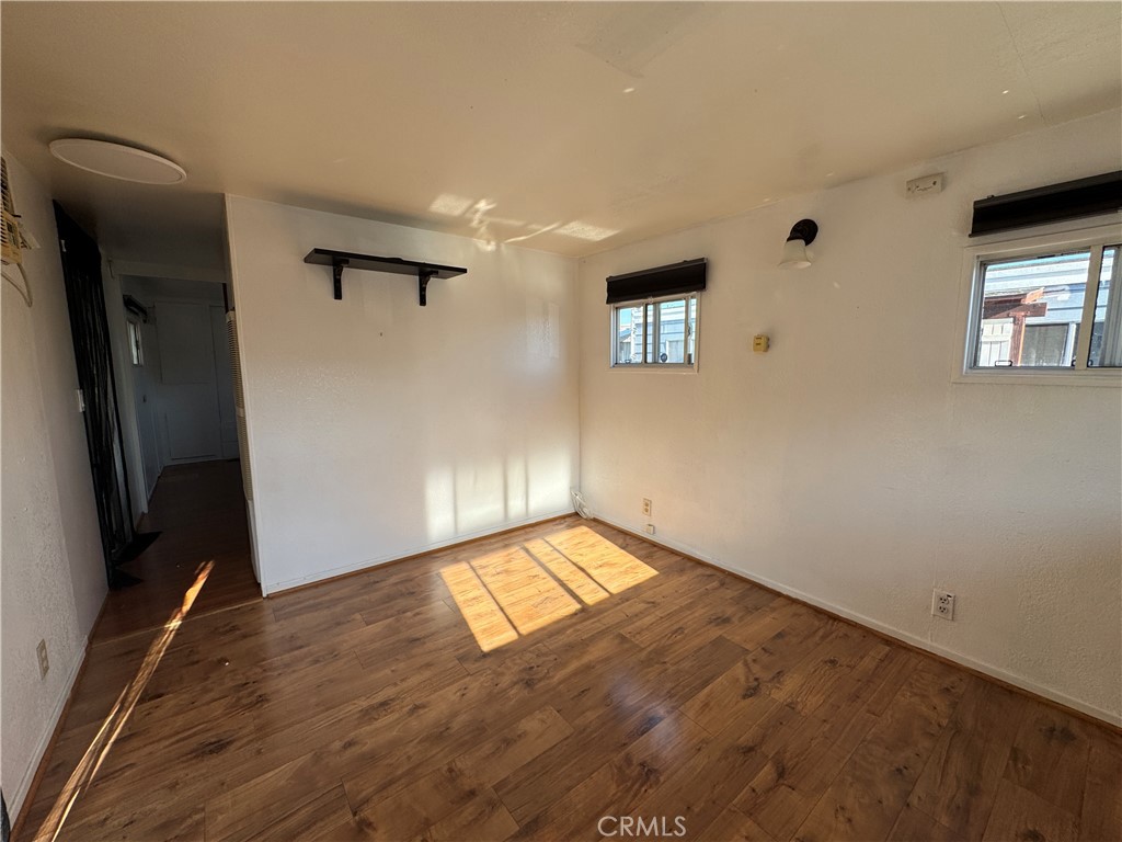 3825 Valley Boulevard, Unit 58 Walnut, CA 91789 - Photo 6 of 11 a view of empty room with wooden floor and fan