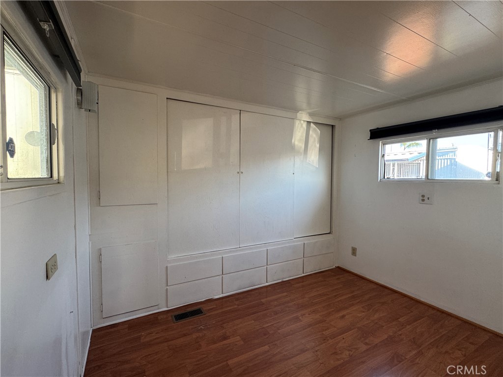 3825 Valley Boulevard, Unit 58 Walnut, CA 91789 - Photo 9 of 11 an empty room with wooden floor and windows