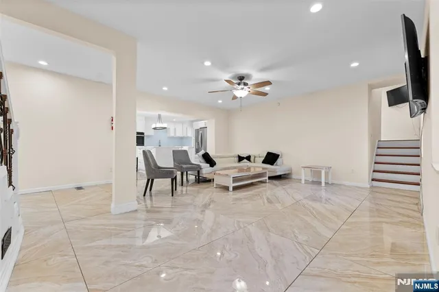 a view of a livingroom with furniture and a flat screen tv