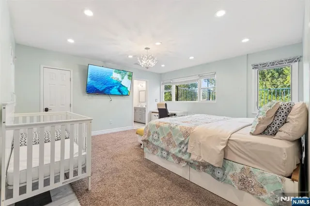 a bedroom with a large bed and a chandelier