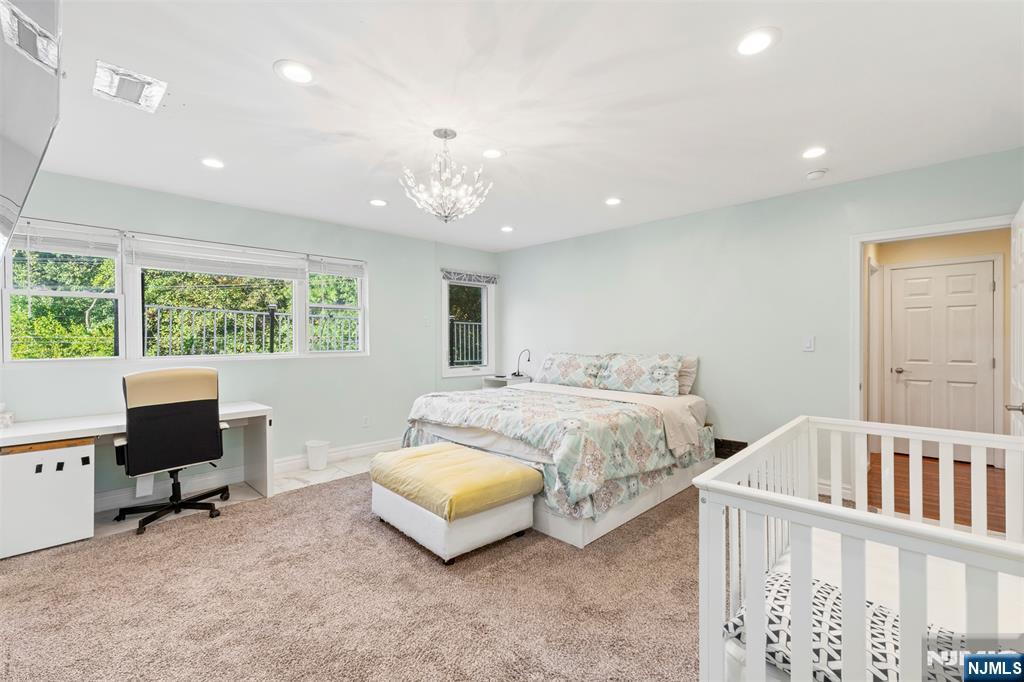 234 Liberty Road Teaneck, NJ 07666 - Photo 16 of 42 a spacious bedroom with a bed and a desk
