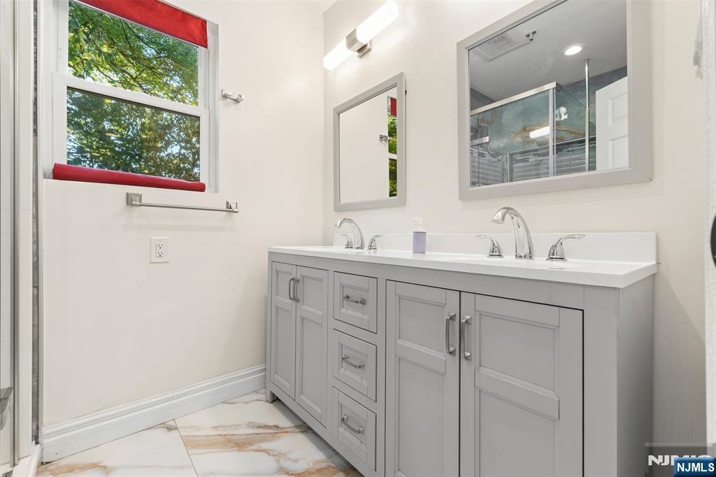 234 Liberty Road Teaneck, NJ 07666 - Photo 17 of 42 a bathroom with a sink and a mirror