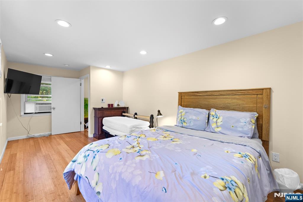 234 Liberty Road Teaneck, NJ 07666 - Photo 20 of 42 a bedroom with a bed and a flat screen tv