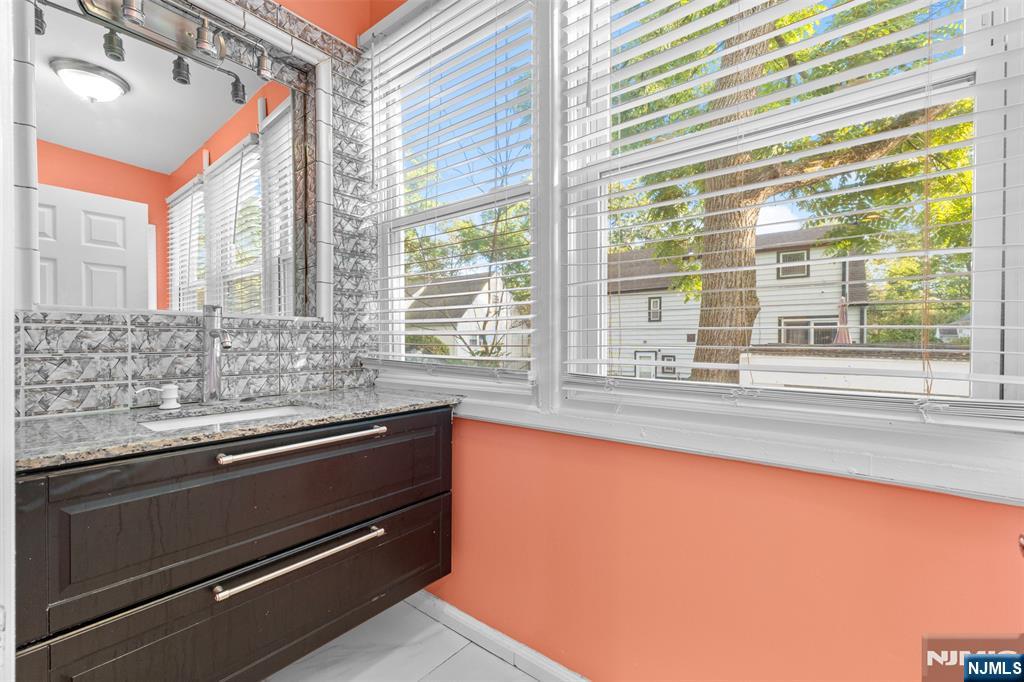 234 Liberty Road Teaneck, NJ 07666 - Photo 22 of 42 a view of a kitchen with a sink and large window