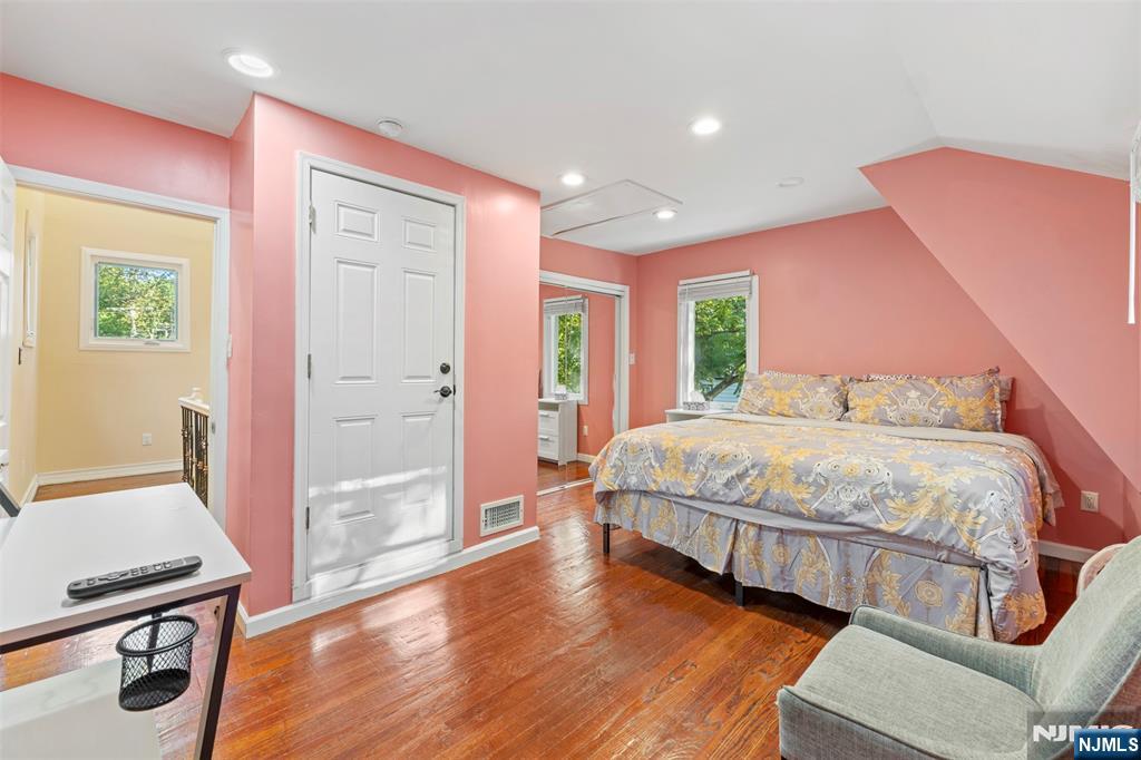 234 Liberty Road Teaneck, NJ 07666 - Photo 27 of 42 a bedroom with a bed and wooden floor