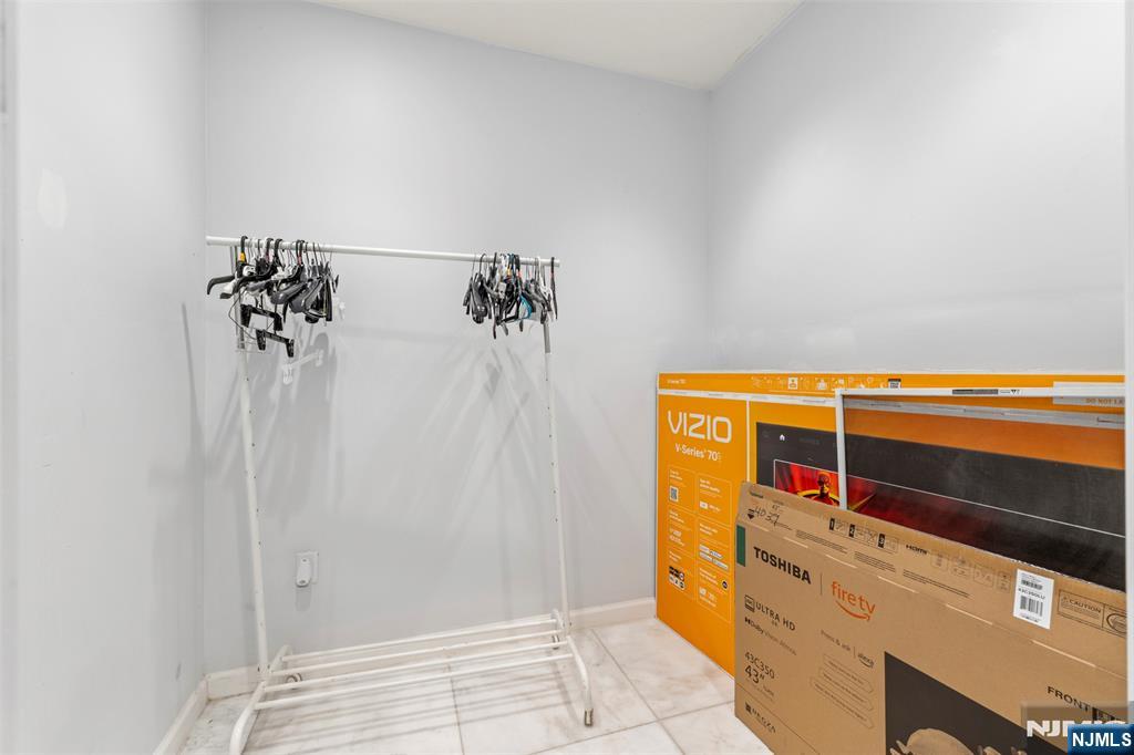 234 Liberty Road Teaneck, NJ 07666 - Photo 28 of 42 a view of walk in closet with clothes and shoes