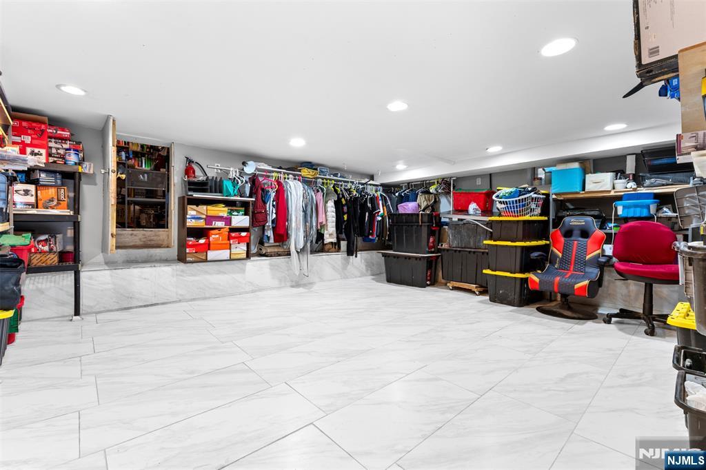 234 Liberty Road Teaneck, NJ 07666 - Photo 29 of 42 a view of a garage with a refrigerator and a car